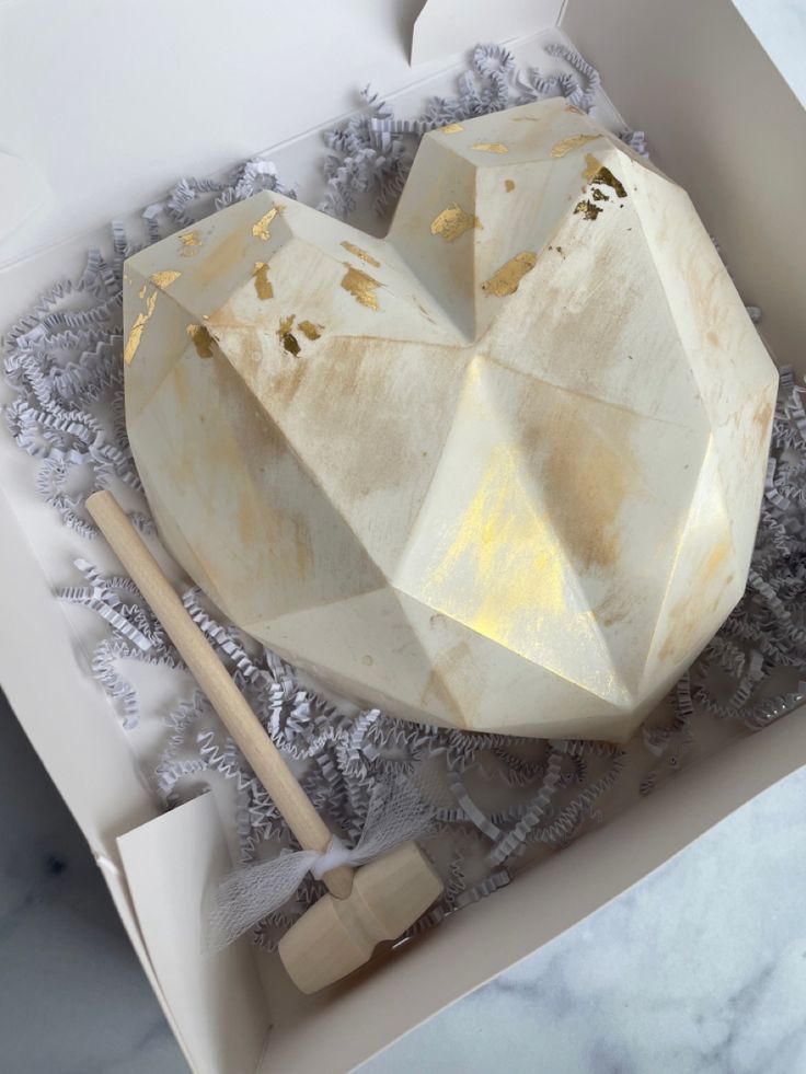 White chocolate breakable heart with gold leaf in gift box