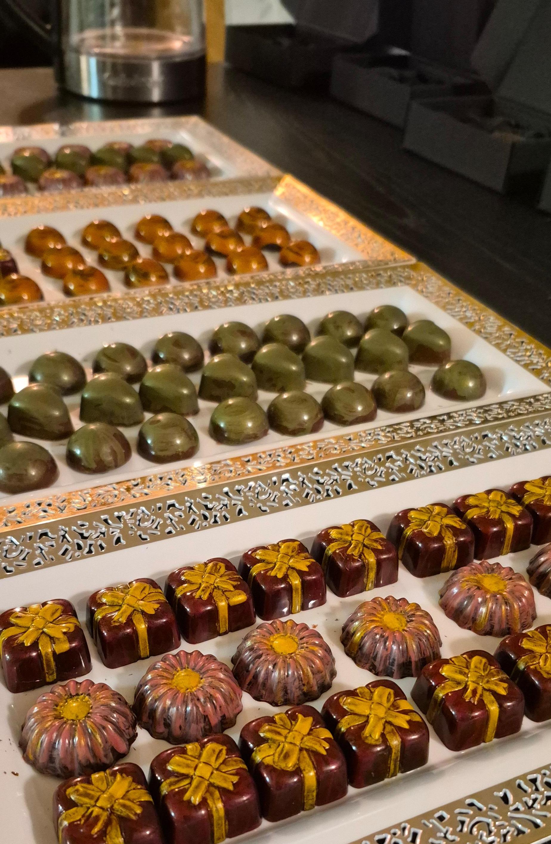 A colourful assortment of artisan chocolates on a gold tray