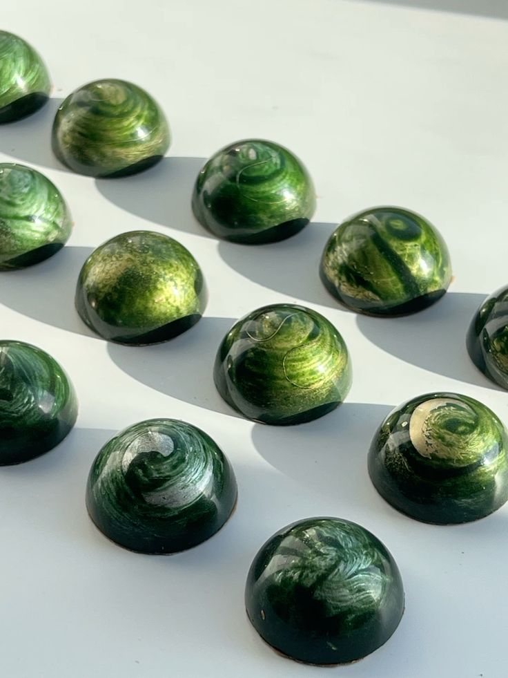 Emerald swirl dome bonbons on white marble