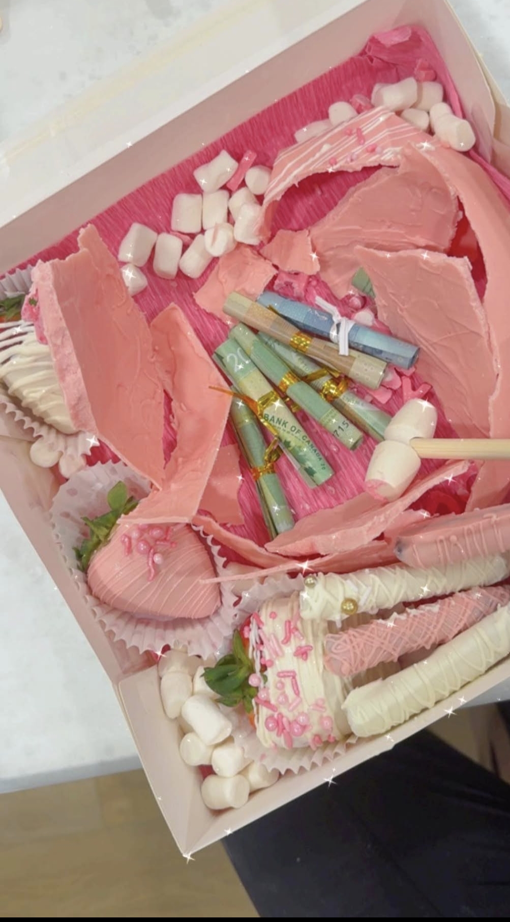 Pink chocolate smash box with chocolate shards and money rolls